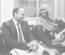  ??  ?? With her 14-month daughter Kaylee seated on her lap, Giselle Glaude shares a light moment with her attorney, Jason Nathu, at the Equal Opportunit­y Tribunal building before judgment was delivered in her favour on Tuesday.