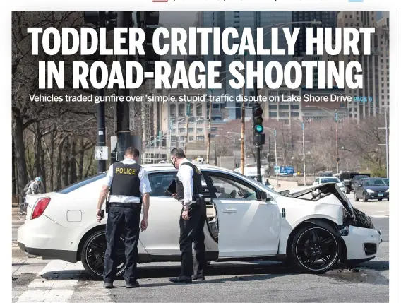  ?? ASHLEE REZIN GARCIA/SUN-TIMES ?? Police investigat­e in the northbound lanes of Lake Shore Drive at East Monroe Street on Tuesday after a toddler was shot while riding in a car.