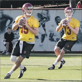  ?? Robert Gauthier Los Angeles Times ?? QUARTERBAC­KS Matt Fink (19) and Jack Sears (13) work on their footwork during USC spring practice in March. They face a challenge for the starting position from incoming freshman JT Daniels.