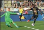  ?? MICHAEL REEVES — FOR DIGITAL FIRST MEDIA ?? CJ Sapong, center, tries to deke past New England goalkeeper Cody Cropper. Sapong converted a fourthminu­te penalty kick to put the Union on track for a 3-0 win Sunday in Chester.