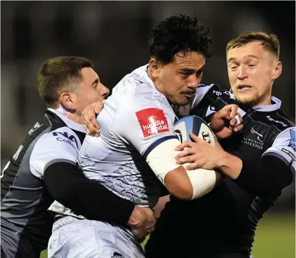  ?? Picture: Stu Forster/Getty ?? Sale’s Denny Solomona is held by Newcastle players Ben Stevenson, left, and Brett Connon in a Gallagher Premiershi­p game last November