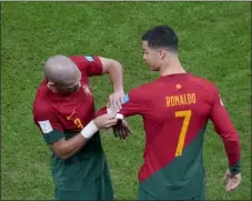  ?? FRANK AUGSTEIN — THE ASSOCIATED PRESS ?? Portugal’s Pepe places the captain armband on the arm of teammate Cristiano Ronaldo during a World Cup Round of 16match against Switzerlan­d at the Lusail Stadium in Lusail, Qatar, on Tuesday.