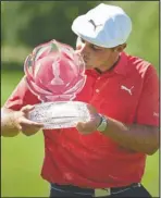  ?? The Associated Press ?? DECHAMBEAU CHAMPION: Bryson DeChambeau kisses the trophy after winning the Memorial golf tournament Sunday in Dublin, Ohio.