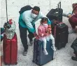  ?? Bloomberg ?? ■ Travellers wait inside the departure hall at West Kowloon Station.