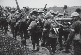  ??  ?? Marked out: World War I soldiers with the identifyin­g tin triangles on their backs