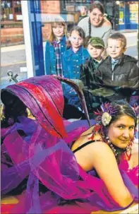  ?? Picture: Steve MacDougall. ?? Shayna McLean, posing as a mermaid, watched by some of the children who attended her storytelli­ng session and Anne Marie MacLellan, from the Cancer Research UK shop.