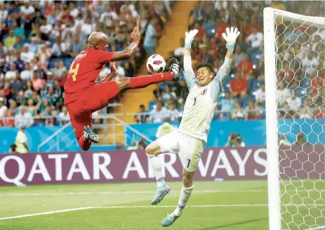  ?? AP ?? Belgium’s Vincent Kompany (left) jumps for the ball in front of Japan goalkeeper Eiji Kawashima during their round of 16 match late on Monday. —