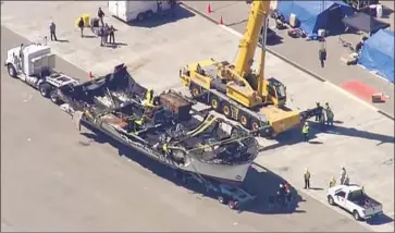  ?? KABC-TV ?? ELECTRICAL OUTLETS used to charge an array of personal devices are now the focus of the investigat­ion into the deadly fire on the Conception, shown sitting atop a big-rig trailer at the Seabee base in Port Hueneme.