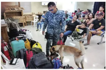 ?? PCG-BACOLOD ?? A K9 dog inspects the baggage of passengers at the Bredco port Tuesday.