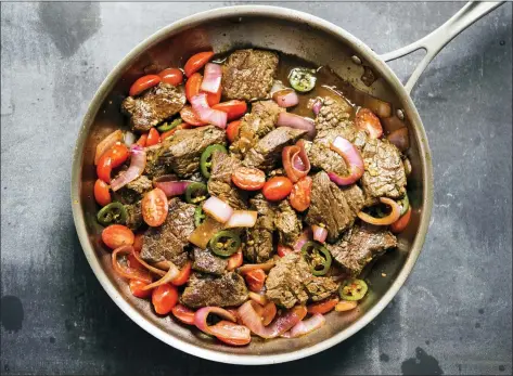  ?? MILK STREET VIA AP ?? This image released by Milk Street shows a recipe for Lomo Saltado.