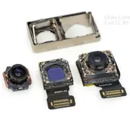  ??  ?? In this iFixit.com photo of the iPhone 8 Plus’ cameras, you can see the extra mount on the wide– angle camera (far right).