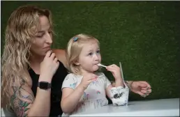  ??  ?? Madelyn Erickson with daughter, Scarlett, 2, both of Lodi, try the Oreo ice cream during the soft opening of House of Ice Cream in Lodi on Friday evening.