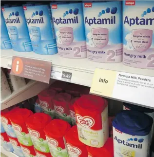  ?? KIRSTY WIGGLESWOR­TH/ THE ASSOCIATED PRESS ?? Some British retailers said Wednesday they are rationing purchases of formula. They suspect the unusually large amount of the product bought by some people is being exported to China.