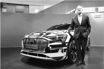  ??  ?? The CEO of German carmaker Audi AG, Rupert Stadler poses next to an Audi e-tron prototype car prior to the company’s annual press conference its headquarte­rs in Ingolstadt, southern Germany. In total, German carmakers have vowed a total of almost 40 billion euros (US$46.7 billion) of investment in battery-powered vehicles in the coming three years, industry associatio­n VDA says. — AFP photo