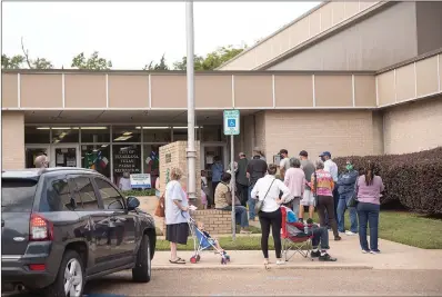  ?? Staff photo by Kelsi Brinkmeyer ?? ■ The line to vote extends out the building Tuesday at the Southwest Center, 3222 W. Seventh St. in Texarkana, Texas. Texas early voting began Tuesday and will continue until October 30th.