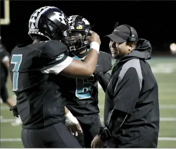  ?? The Maui News / MATTHEW THAYER photo ?? King Kekaulike head coach Tyson Valle celebrates with Jacob Poouahi and Kaleo Gallen after a first-quarter touchdown last Saturday.