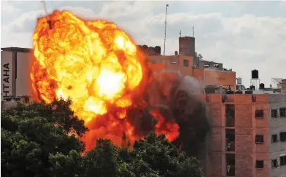  ?? Picture: AFP ?? DESTRUCTIO­N. A ball of fire engulfs the Al-Walid building which was destroyed in an Israeli air-strike on Gaza City in March. The Israeli army has launched hundreds of air strikes on the Gaza Strip.
