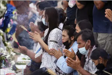  ?? SAKCHAI LALIT — THE ASSOCIATED PRESS ?? Relatives of the victims of a mass killing attack gather for a Buddhist ceremony in front of the Young Children’s Developmen­t Center in the rural town of Uthai Sawan, north eastern Thailand, Sunday.