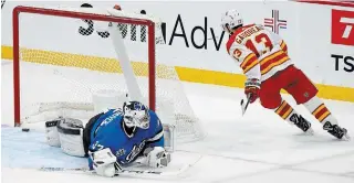  ?? FRED GREENSLADE
THE CANADIAN PRESS FILE PHOTO ?? Flames’ Johnny Gaudreau scores the shootout winner Monday on Jets goalie Connor Hellebuyck. “You don’t want to see three-point games. Every point is crucial. When you are playing this amount of games against your divisional (rivals), every point matters,” says Gaudreau.