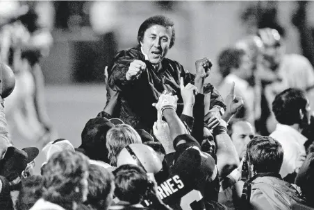  ?? Associated Press 1984 ?? Los Angeles Raiders coach Tom Flores is carried off the field after their Super Bowl win over Washington after the 1983 season.