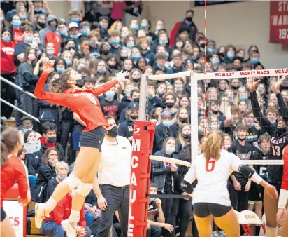  ?? VINCENT D. JOHNSON/DAILY SOUTHTOWN PHOTOS ?? Ellie White gets up for the kill for the host Mighty Macs against Marist during the Class 4A Mother McAuley Sectional final on Wednesday.