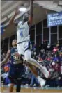  ?? KEN FURLICH — THE NEWS-HERALD ?? Benedictin­e’s Davin Zeigler shoots as Garfield Heights’ Alex Heath looks on last season.