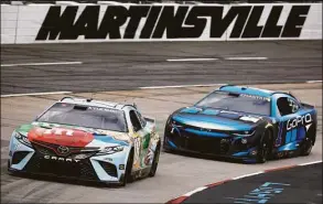  ?? Jared C. Tilton / Getty Images ?? Kyle Busch, driver of the No. 18 M&M’s Crunchy Cookie Toyota, and Ross Chastain, driver of the No. 1 GoPro Chevrolet, drive during practice on Friday for the NASCAR Cup Series Blue-Emu Maximum Pain Relief 400 at Martinsvil­le Speedway in Martinsvil­le, Va.