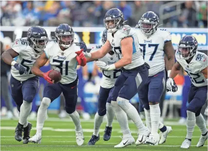  ?? ASHLEY LANDIS/ AP ?? Titans safety Kevin Byard (31) celebrates with teammates after intercepti­ng a pass against the Los Angeles Chargers on Dec. 18 in Inglewood, Calif.