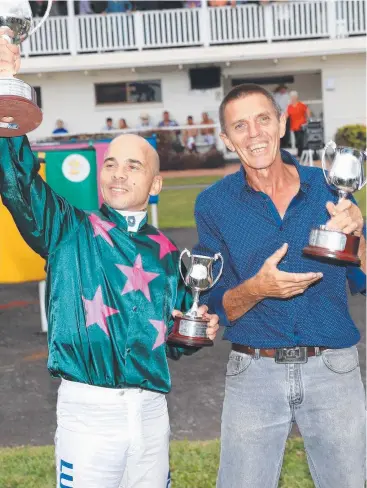  ?? Picture: JUSTIN BRIERTY ?? TRIUMPH: Jockey Wanderson D'Avila and trainer Alwyn Bailey, celebrate their victory after winning the 2017 Cairns Amateurs Cup with recently retired 10-year-old gelding Ranked.