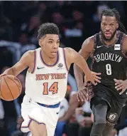  ?? [AP PHOTO] ?? Allonzo Trier (14) of the New York Knicks drives to the basket against the Brooklyn Nets’ DeMarre Carroll (9) during an Dec. 8 game. Trier, who played for the OKC Storm high school team, received a guaranteed deal from the Knicks on Thursday.