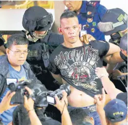 ?? AP ?? Police take hostage taker Archie Paray into custody as he speaks to media shortly after releasing all his hostages at the V-Mall in Manila, Philippine­s, yesterday.