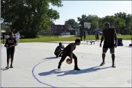  ??  ?? Euclid’s Recreation Director Mac Stephens (far right) plays basketball with some neighborho­od children at the Bluestone basketball courts’ grand opening celebratio­n.