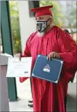  ??  ?? Ralph Chavez shares his certificat­e with those in attendance during Friday’s graduation ceremony.