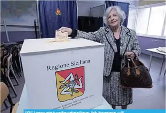  ?? —AP ?? SICILY: A woman votes in a polling station in Palermo, Sicily, Italy yesterday.