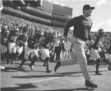  ?? GREGORY SHAMUS/GETTY IMAGES. ?? Head coach Jim Harbaugh of the Michigan Wolverines says he learned “several things” after a botched punt led to a loss to Michigan State last year. The bitter rivals meet again Saturday.