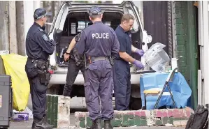  ??  ?? Police tape up evidence outside a house in the inner Sydney suburb of Surry Hills. — AFP photo