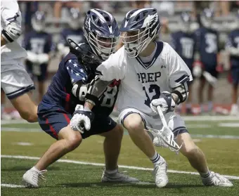  ?? MARY SCHWALM / BOSTON HERALD ?? REVENGE: St John’s Prep’s Jimmy Ayers (12) protects the ball from Lincoln-Sudbury defender Zachary Lucchini during the first half of the Div. 1 North final.