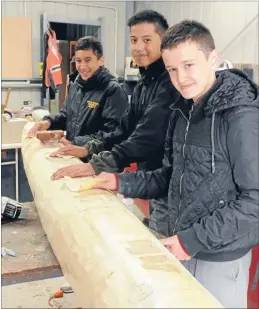  ??  ?? Waka work: From left, Levi Skelton, Te Atawhai Amaru-Tibble and Jaimie Ngatoko get some last-minute sanding done last week.