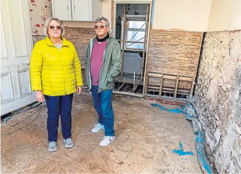  ??  ?? FLOODED OUT: Kate and Steve Hampshaw inside their Kinglassie home which was badly damaged during Storm Francis in August. Picture by Steve Brown.