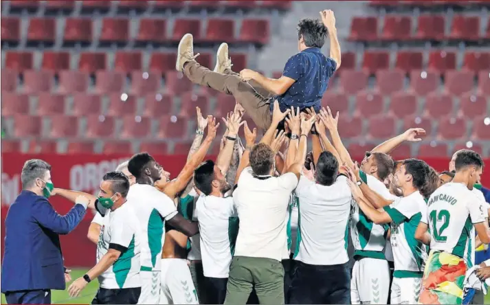  ??  ?? Los jugadores del Elche mantean a su técnico Pacheta en el cesped de Montilivi tras conseguir su ascenso a Primera División.