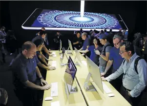  ?? AP PHOTO ?? Journalist­s look at new iMacs in a showroom Monday at the Apple Worldwide Developers Conference in San Jose, Calif.