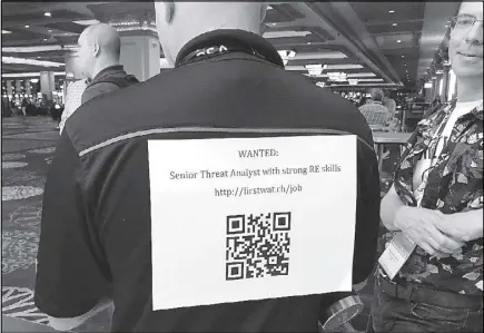  ?? REUTERS ?? A recruiter advertises a QR code to attract hackers to apply for jobs at the Black Hat security conference in Las Vegas, Nevada.