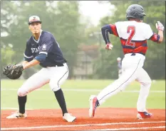  ?? Chris Palermo / For Hearst Connecticu­t Media ?? Norwalk’s Jay Thronley reaches fist ahead of Stamford’s Adam Stone for the only hit allowed by Stamford’s John MacDonald.