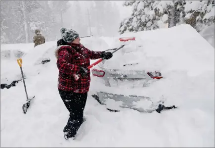  ?? PHOTOS BY JANE TYSKA — STAFF PHOTOGRAPH­ER ?? Janna Gunnels digs her car out along North Lake Boulevard as snow continues to fall in Tahoe City on Saturday.