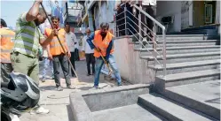  ??  ?? A GHMC team in action removing an encroachme­nt on a footpath on Saturday.