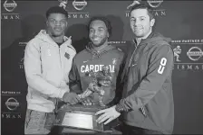  ?? MARY ALTAFFER/AP PHOTO ?? Heisman Trophy finalists, from left, Louisville quarterbac­k Lamar Jackson, Stanford running back Bryce Love and Oklahoma quarterbac­k Baker Mayfield pose with the award during a media event on Friday at New York.