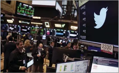  ?? (AP/Seth Wenig) ?? The Twitter symbol appears above a trading post Tuesday on the floor of the New York Stock Exchange. Trading in shares of Twitter was halted for much of the day after the stock spiked on reports that Elon Musk would proceed with his $44 billion deal to buy the company after months of legal battles.