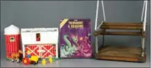  ?? THE ASSOCIATED PRESS ?? The three inductees into the National Toy Hall of Fame’s class of 2016, from left, Fisher-Price Little People, Dungeons & Dragons and the swing, are on display.