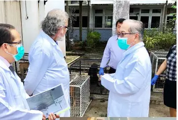  ??  ?? Uggah (right) and the writer of the article (second left) are briefed by Dr Adrian during their visit to the State Veterinary Diagnostic Laboratory (SVDL) in Kota Samarahan.