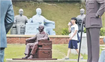  ??  ?? File photo shows a tourist walking among statues of Chiang at a park in Taoyuan, northern Taiwan. — AFP photo